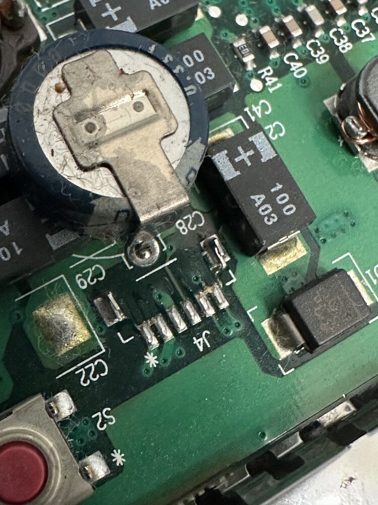 Clamshell iBook board close-up during backlight connector repair planning