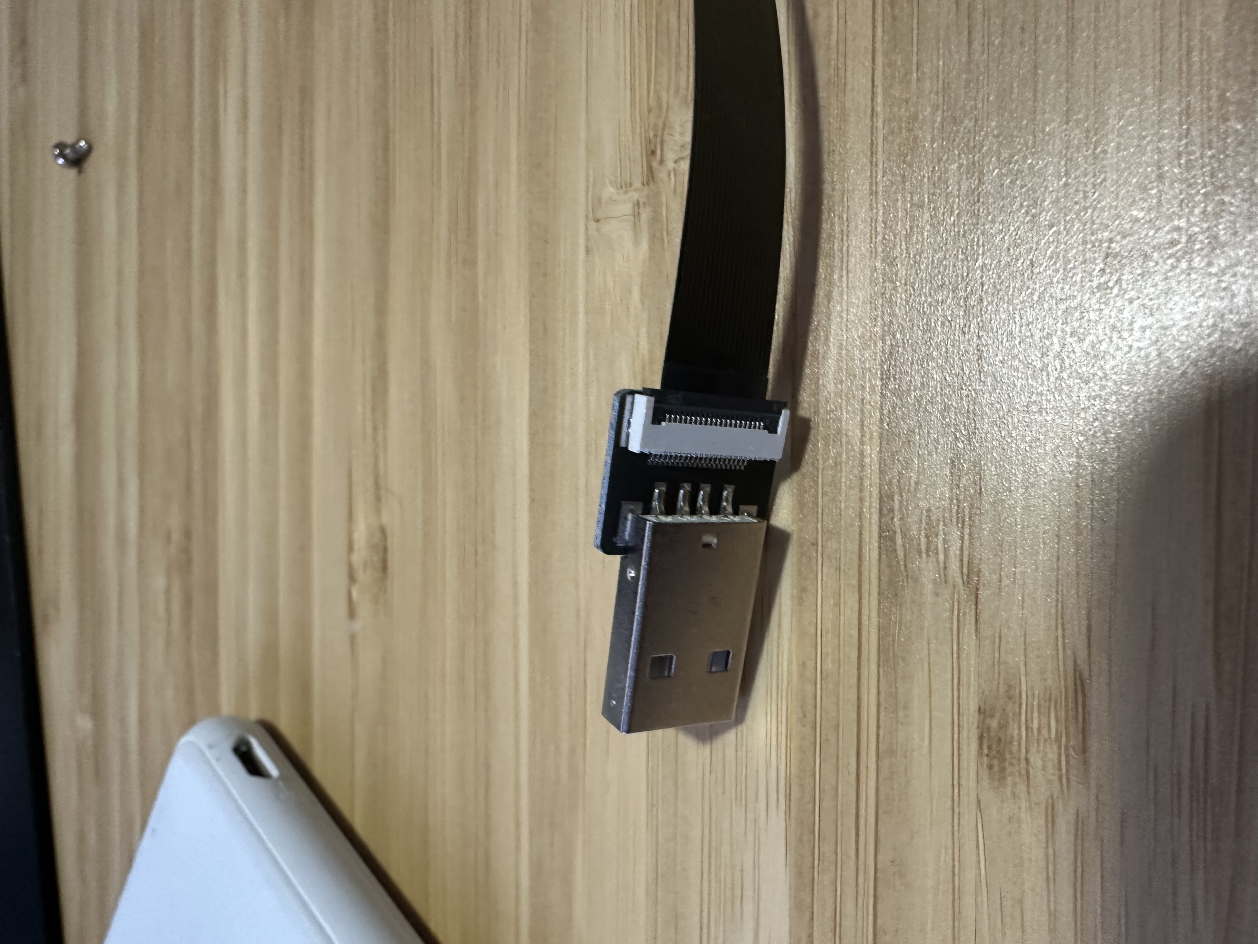 Replacement SCSI cable installed inside the PowerBook with the storage bay exposed