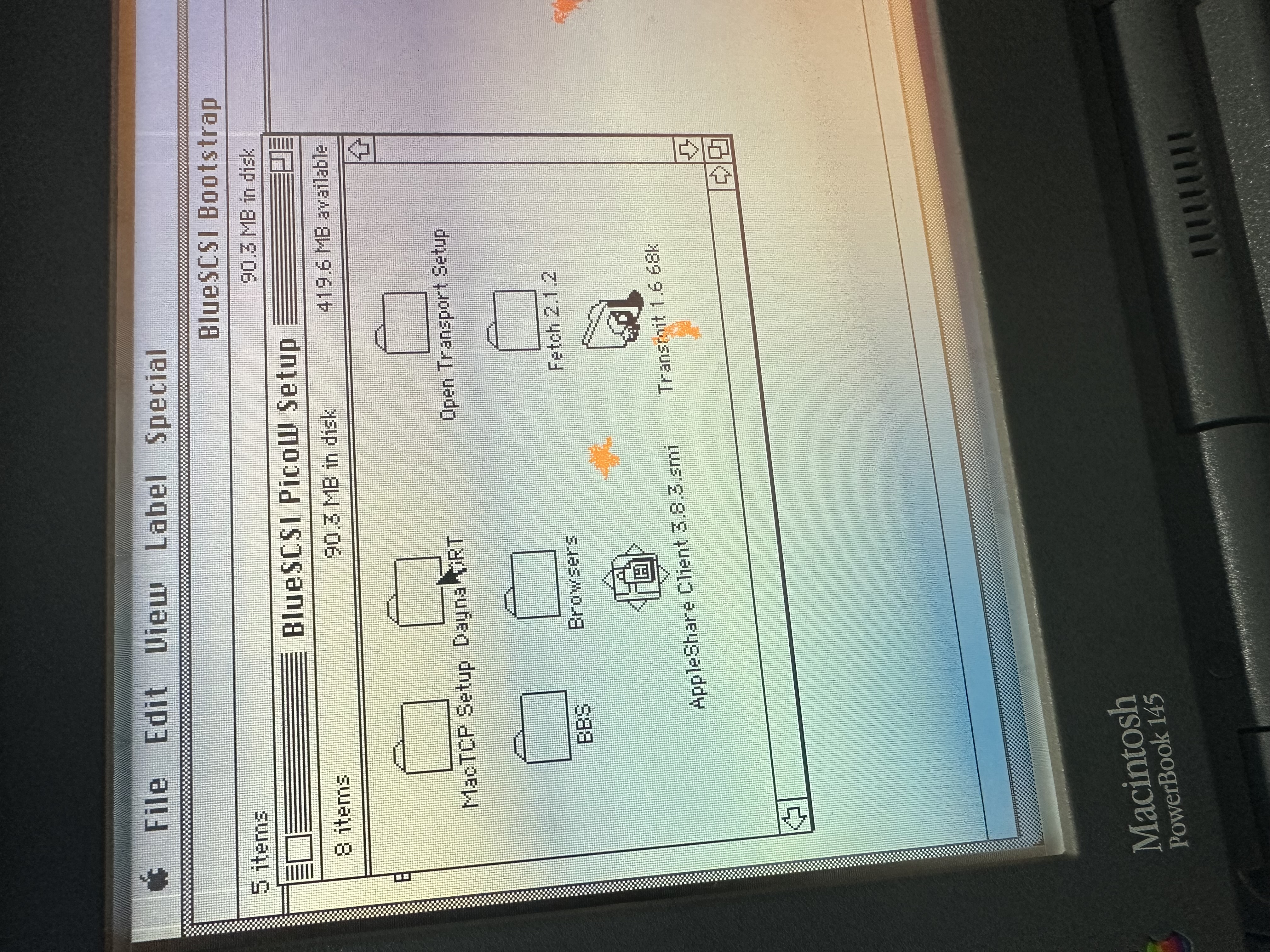 Classic Mac desktop showing BlueSCSI helper volumes and staged applications