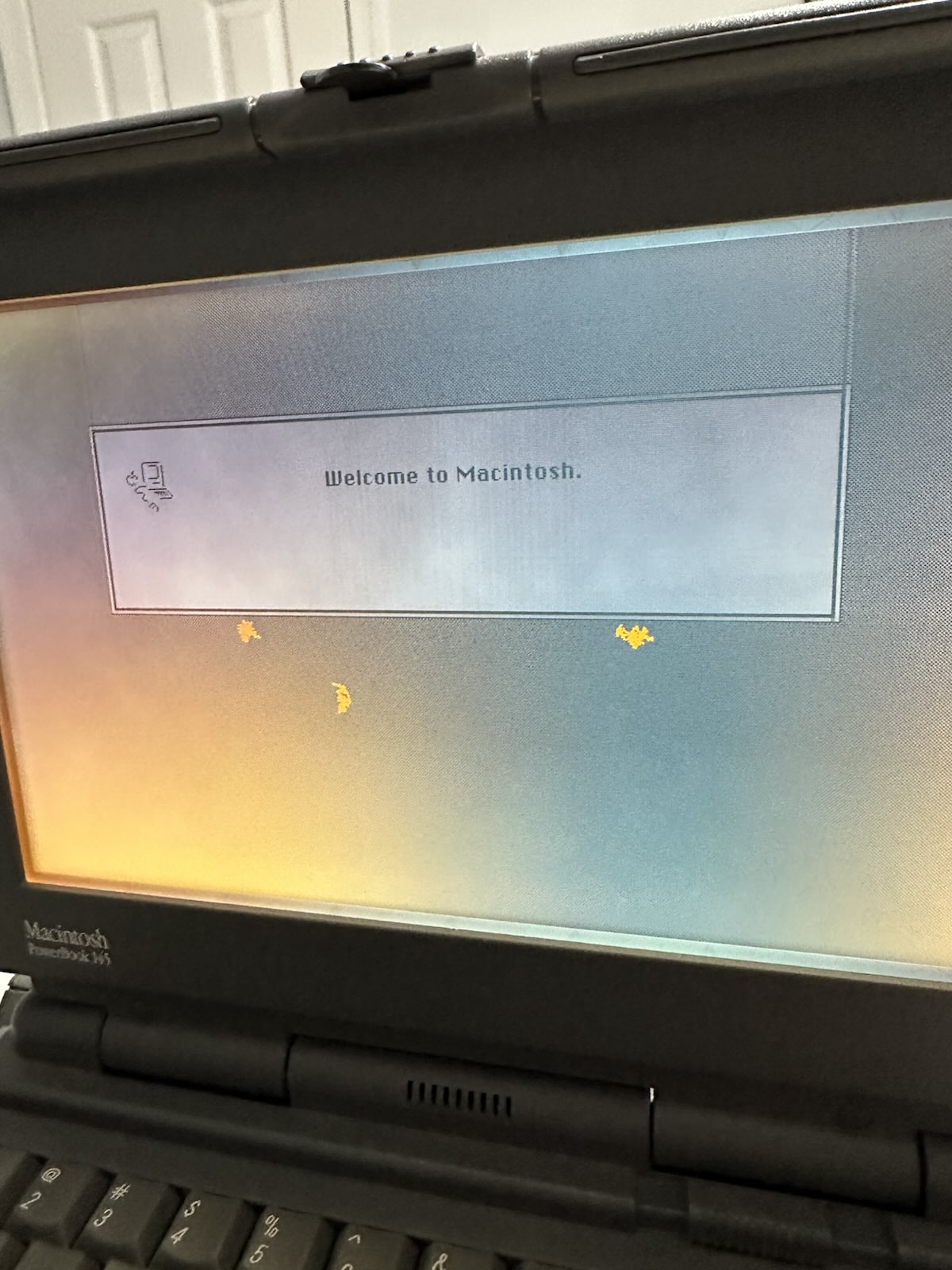 PowerBook 145 showing the Welcome to Macintosh startup screen